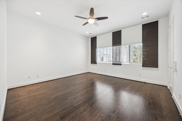 spare room with ceiling fan and dark hardwood / wood-style flooring