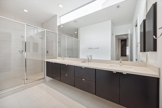 bathroom with vanity, tile patterned flooring, and a shower with door