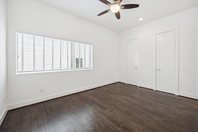 unfurnished bedroom with ceiling fan and dark hardwood / wood-style flooring