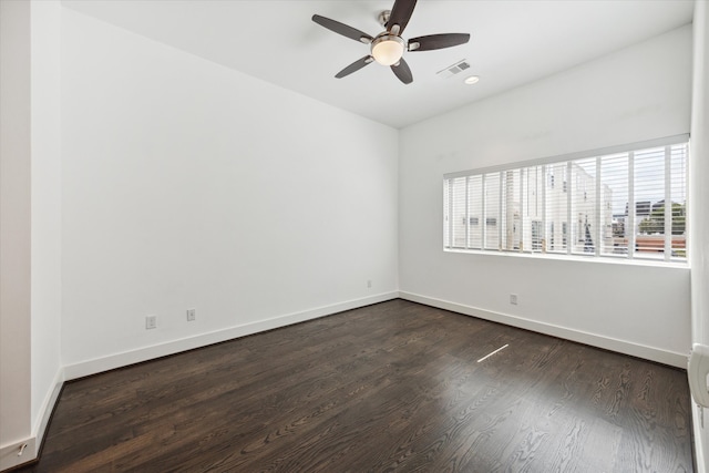 spare room with ceiling fan and dark hardwood / wood-style flooring