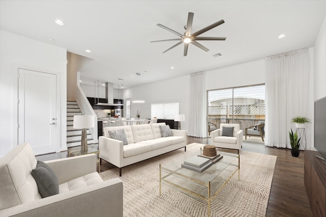 living room with hardwood / wood-style flooring and ceiling fan