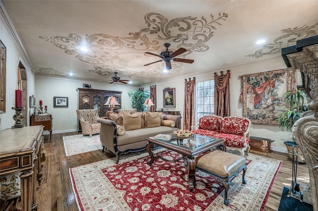 living room with baseboards, wood finished floors, ornamental molding, and a ceiling fan