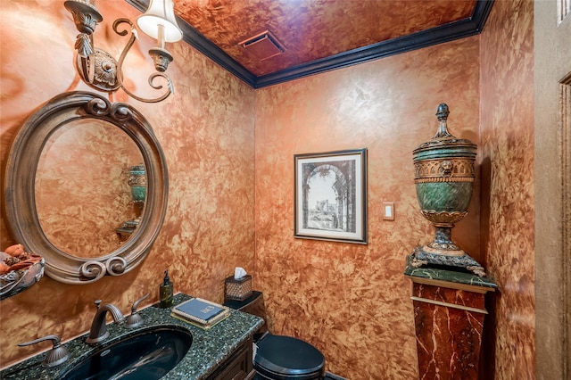 half bath with visible vents, vanity, toilet, and crown molding