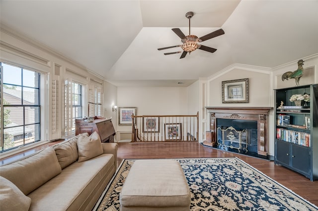 living room featuring lofted ceiling, wood-type flooring, crown molding, and ceiling fan