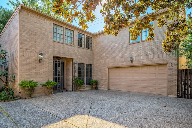 view of front of house with a garage, brick siding, and concrete driveway