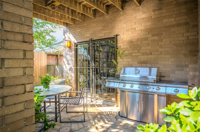 view of patio / terrace with outdoor dining space, fence, and a grill