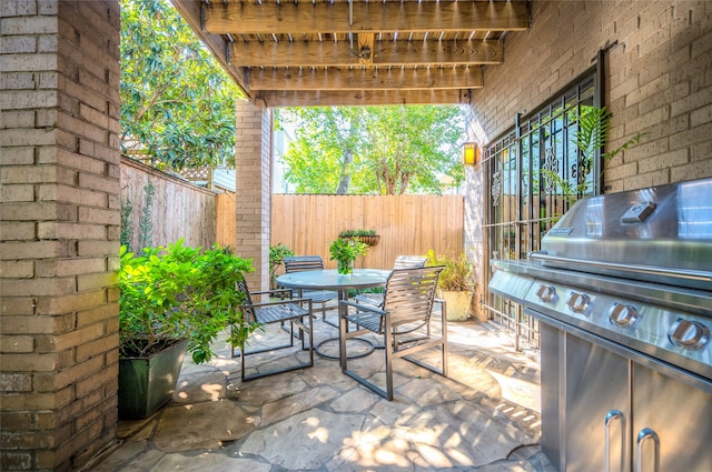 view of patio / terrace featuring grilling area, outdoor dining area, and a fenced backyard