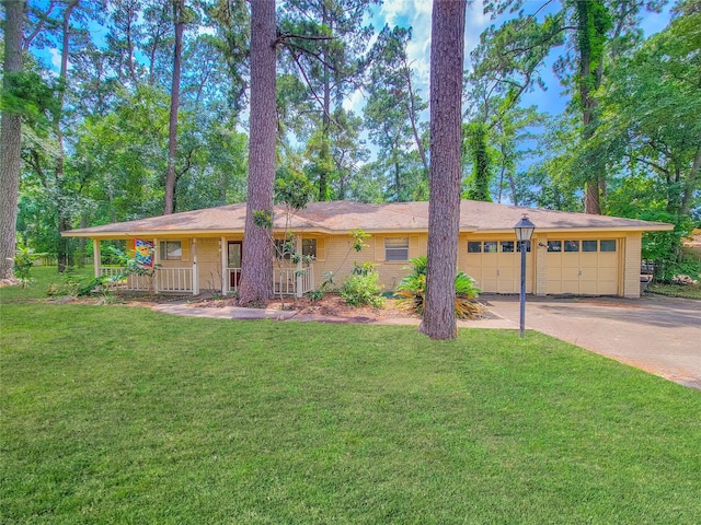 ranch-style home featuring a front yard, a garage, and a porch