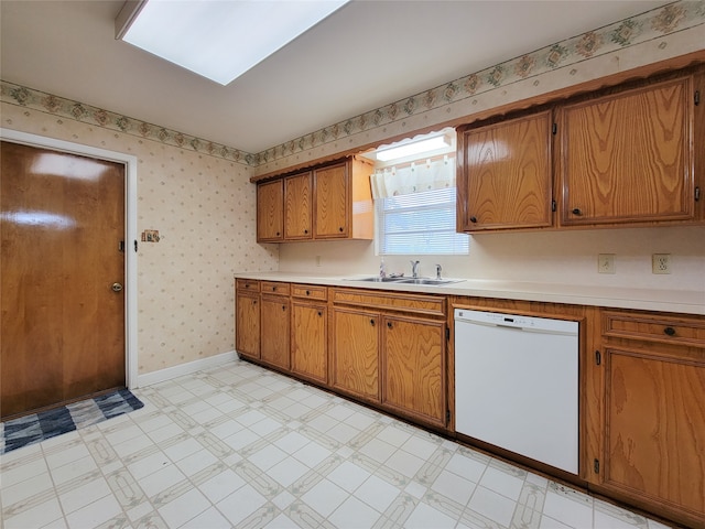 kitchen featuring white dishwasher and sink