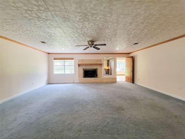 unfurnished living room featuring carpet floors, crown molding, a fireplace, and ceiling fan