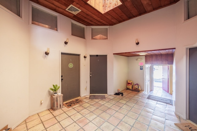 foyer with a high ceiling and wood ceiling