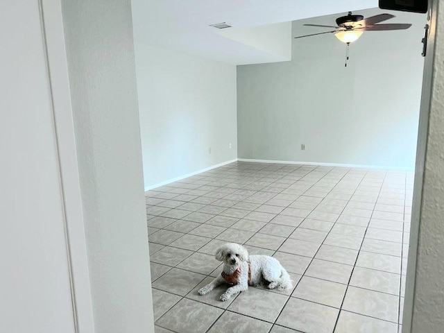 tiled empty room with ceiling fan