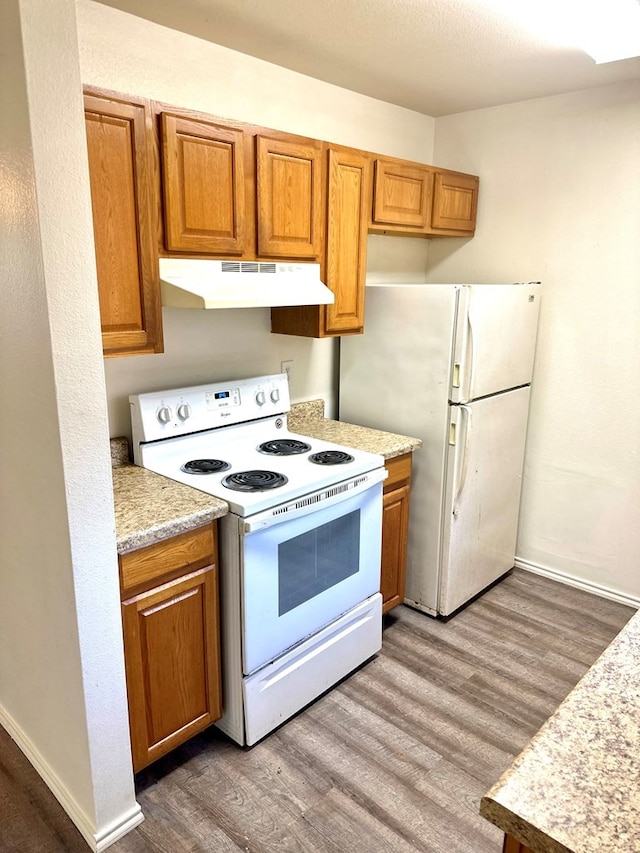 kitchen featuring white appliances and wood-type flooring