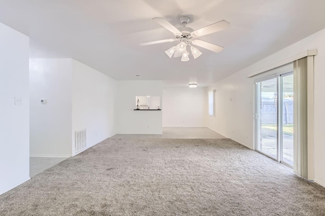 spare room featuring ceiling fan and carpet