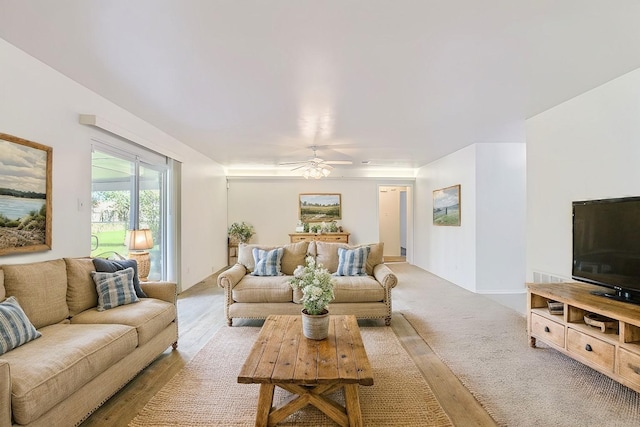 living room featuring light colored carpet and ceiling fan