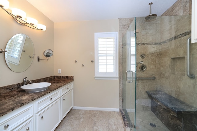 bathroom featuring tile patterned floors, vanity, and a shower with shower door