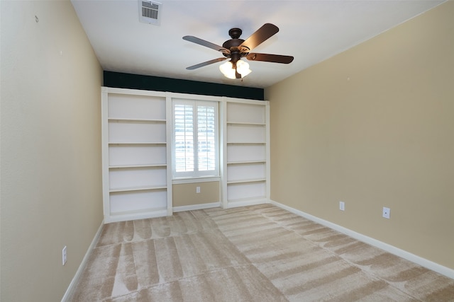 unfurnished bedroom featuring ceiling fan and light carpet