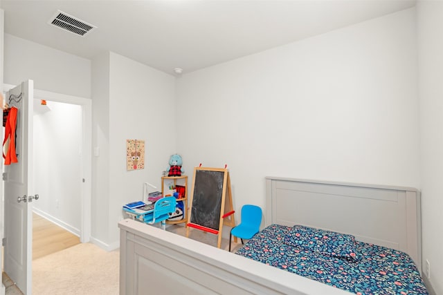 bedroom featuring light carpet