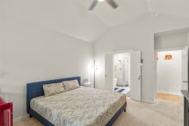 bedroom featuring ceiling fan, vaulted ceiling, light colored carpet, and ensuite bathroom