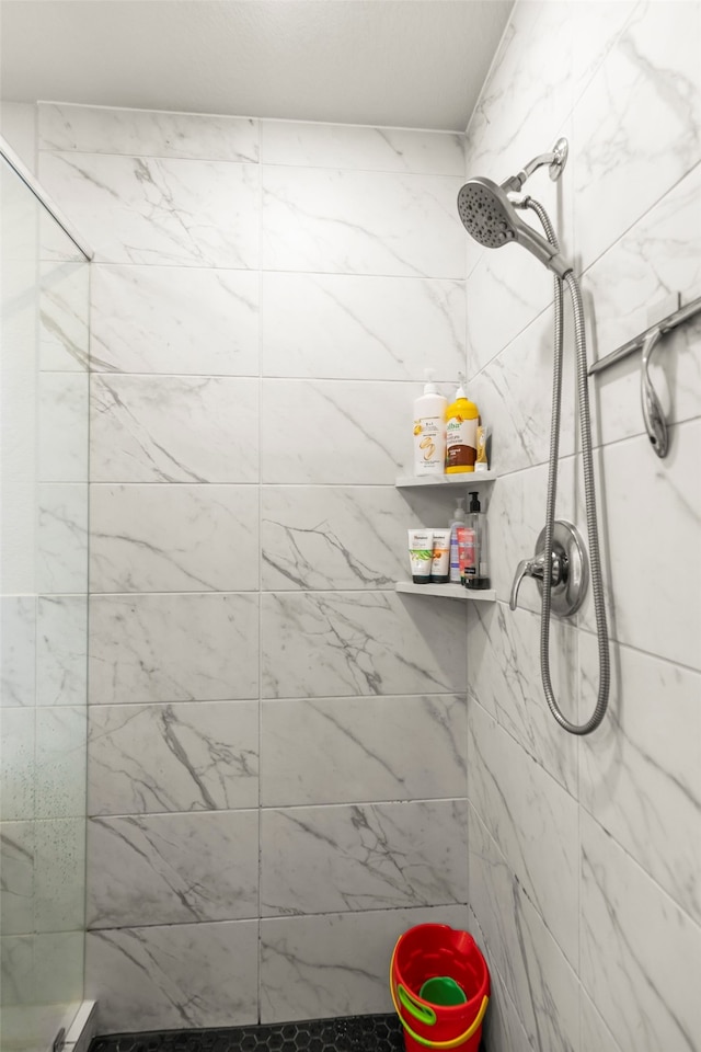 bathroom with a tile shower