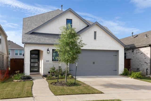 view of front of house with a garage and a front lawn