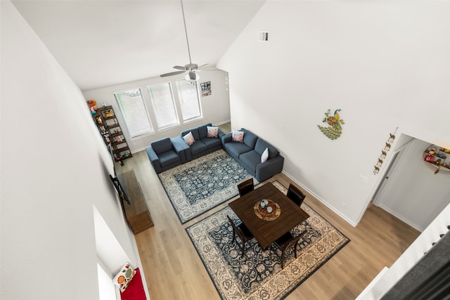 living room with high vaulted ceiling, hardwood / wood-style floors, and ceiling fan