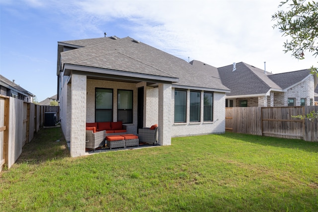 back of property with outdoor lounge area, cooling unit, a yard, and a patio