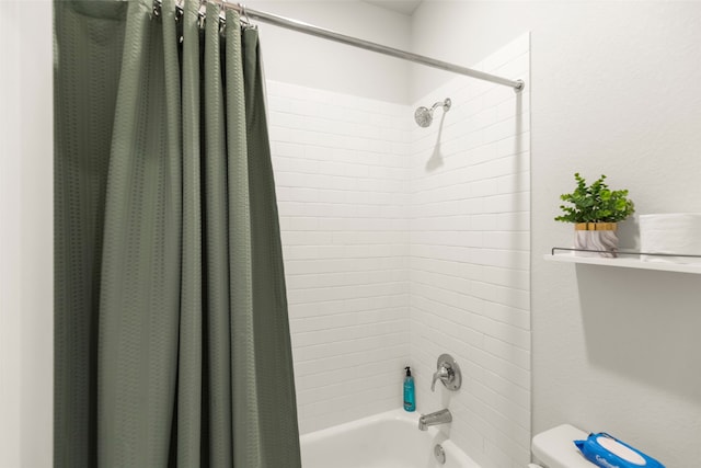 bathroom featuring shower / bath combination with curtain and toilet