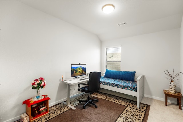 carpeted office featuring lofted ceiling