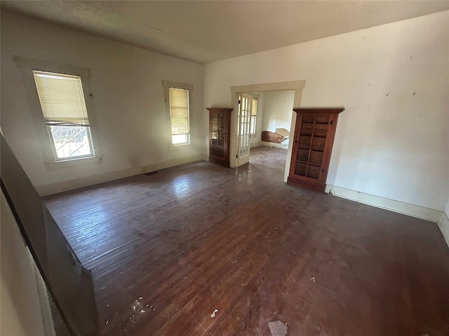 spare room with dark wood-type flooring