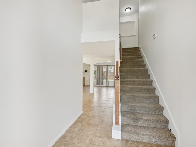 stairs with tile patterned flooring