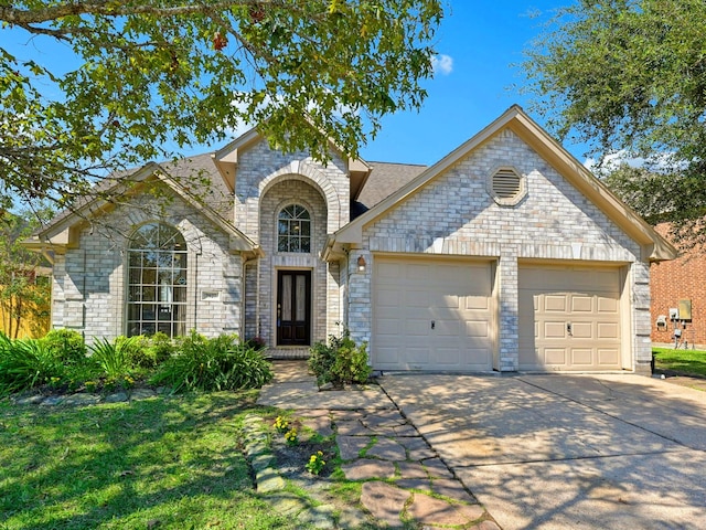 view of front of property featuring a front yard and a garage