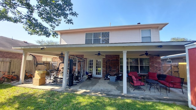 rear view of house with ceiling fan and a patio