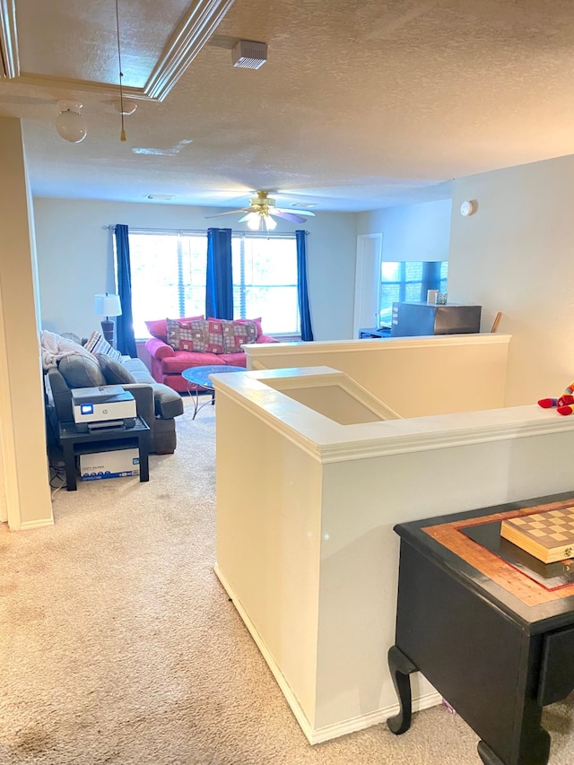 carpeted living room with a textured ceiling and ceiling fan