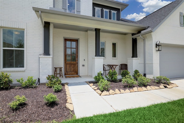 property entrance with a garage and covered porch