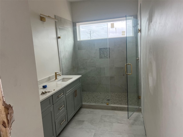 bathroom with vanity and a shower with shower door