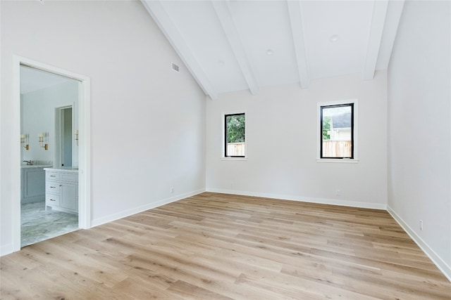 spare room with lofted ceiling with beams, sink, and light hardwood / wood-style flooring