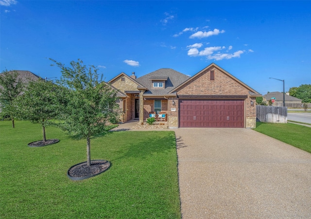 view of front of house featuring a front yard and a garage