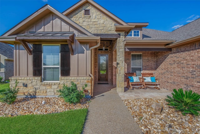 view of exterior entry with a patio