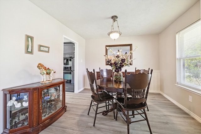 dining area with hardwood / wood-style floors and a notable chandelier