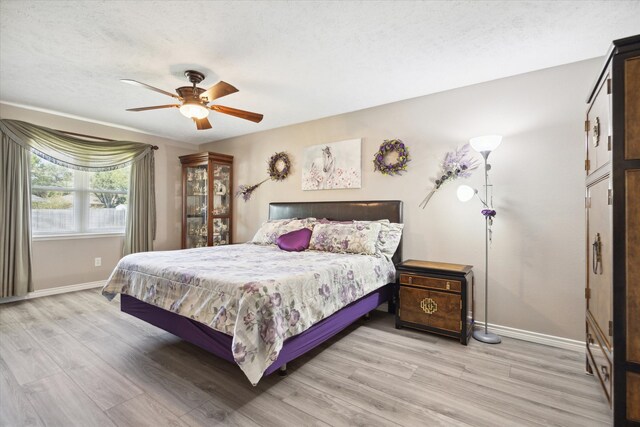 bedroom featuring ceiling fan and light hardwood / wood-style flooring