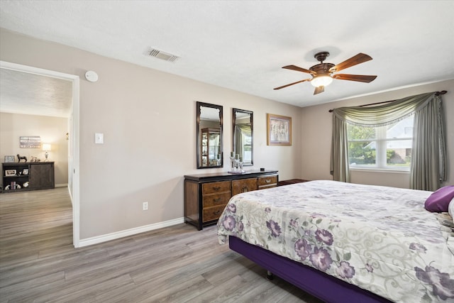 bedroom featuring ceiling fan and light hardwood / wood-style flooring