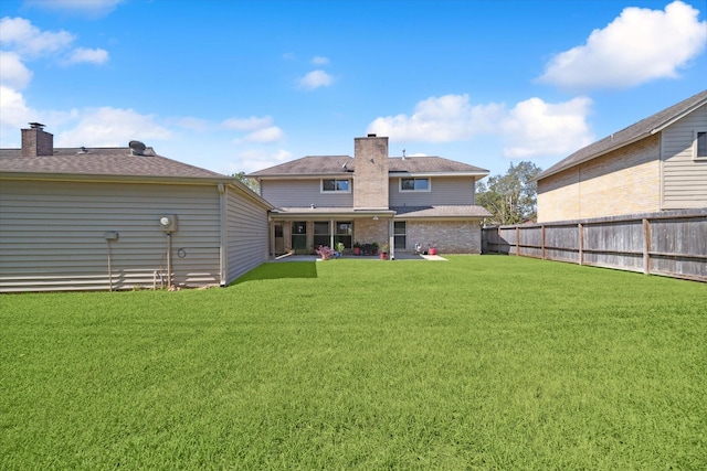 back of house with a yard