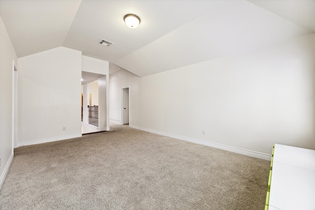 interior space featuring lofted ceiling and carpet