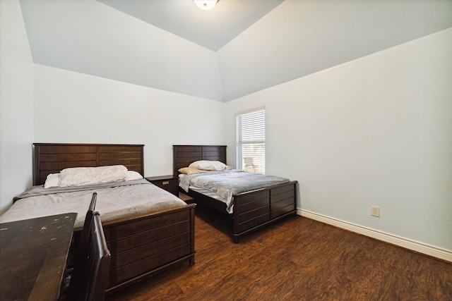 bedroom featuring lofted ceiling and dark wood-type flooring