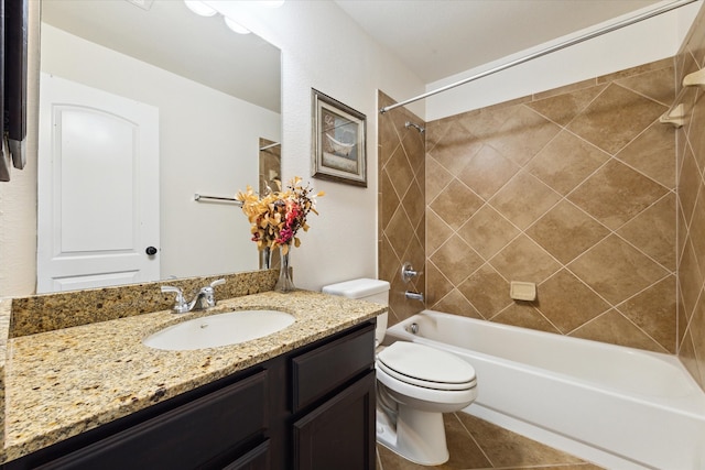 full bathroom with toilet, tiled shower / bath, vanity, and tile patterned flooring