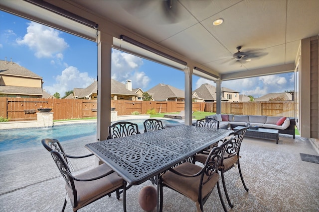 view of patio / terrace with a fenced in pool, ceiling fan, and an outdoor hangout area