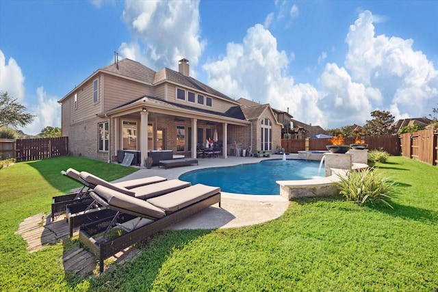 view of swimming pool with a yard, a patio, and pool water feature