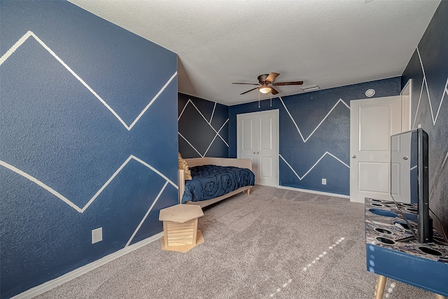 unfurnished bedroom featuring carpet floors, a textured ceiling, and ceiling fan