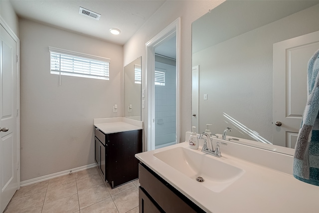 bathroom with tile patterned floors and vanity